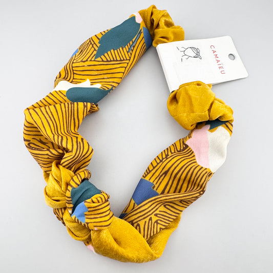 Mustard patterned headband Camaïeu arranged to show its gathered band and front knot