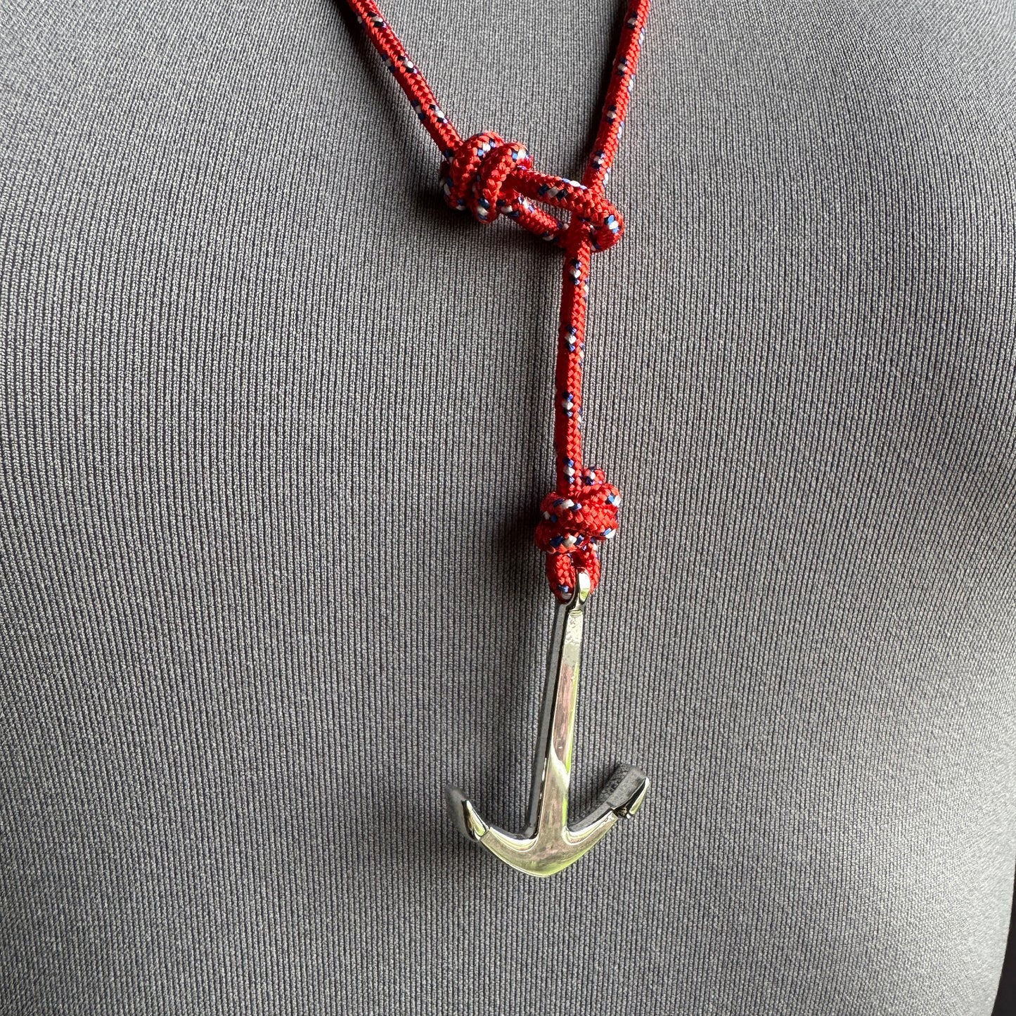 Shiny anchor pendant on red rope necklace with navy pattern