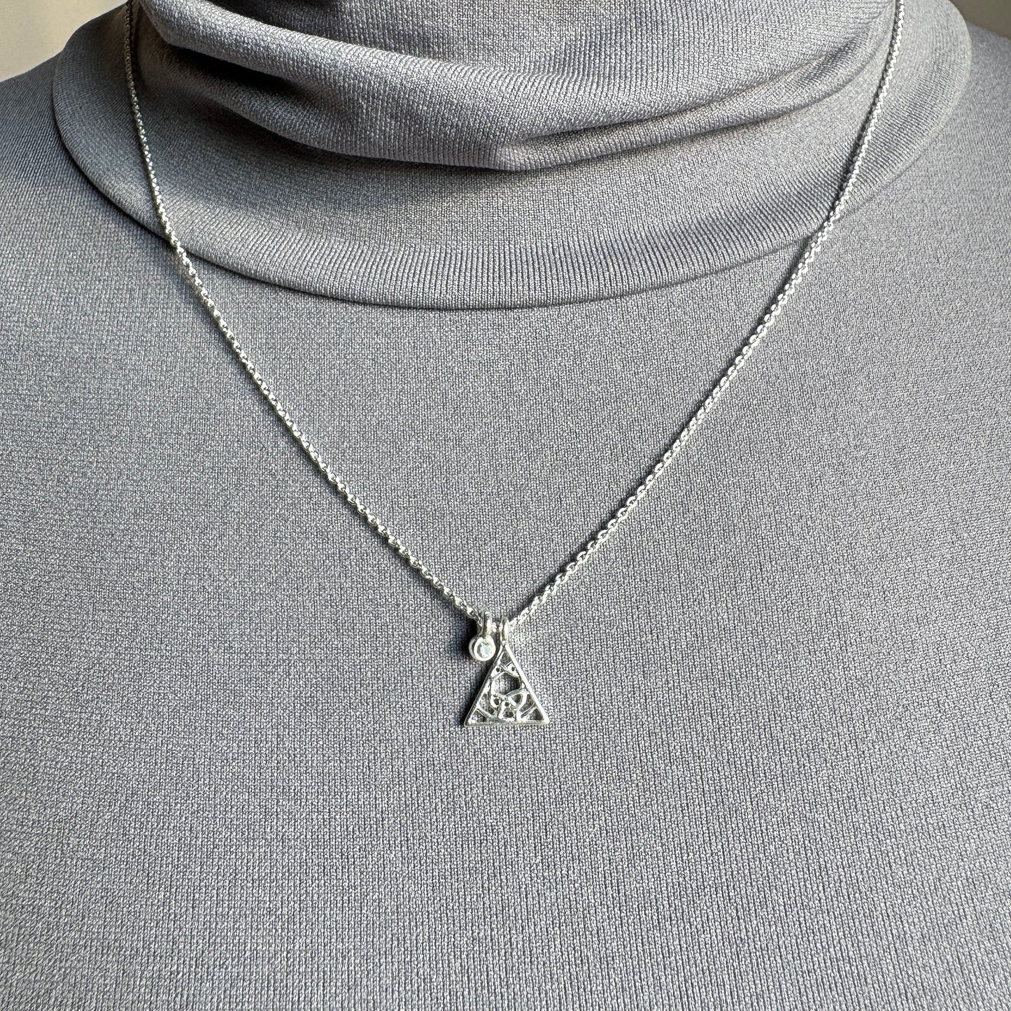 Pilgrim silver necklace with delicate triangle pendant and crystal worn on neck
