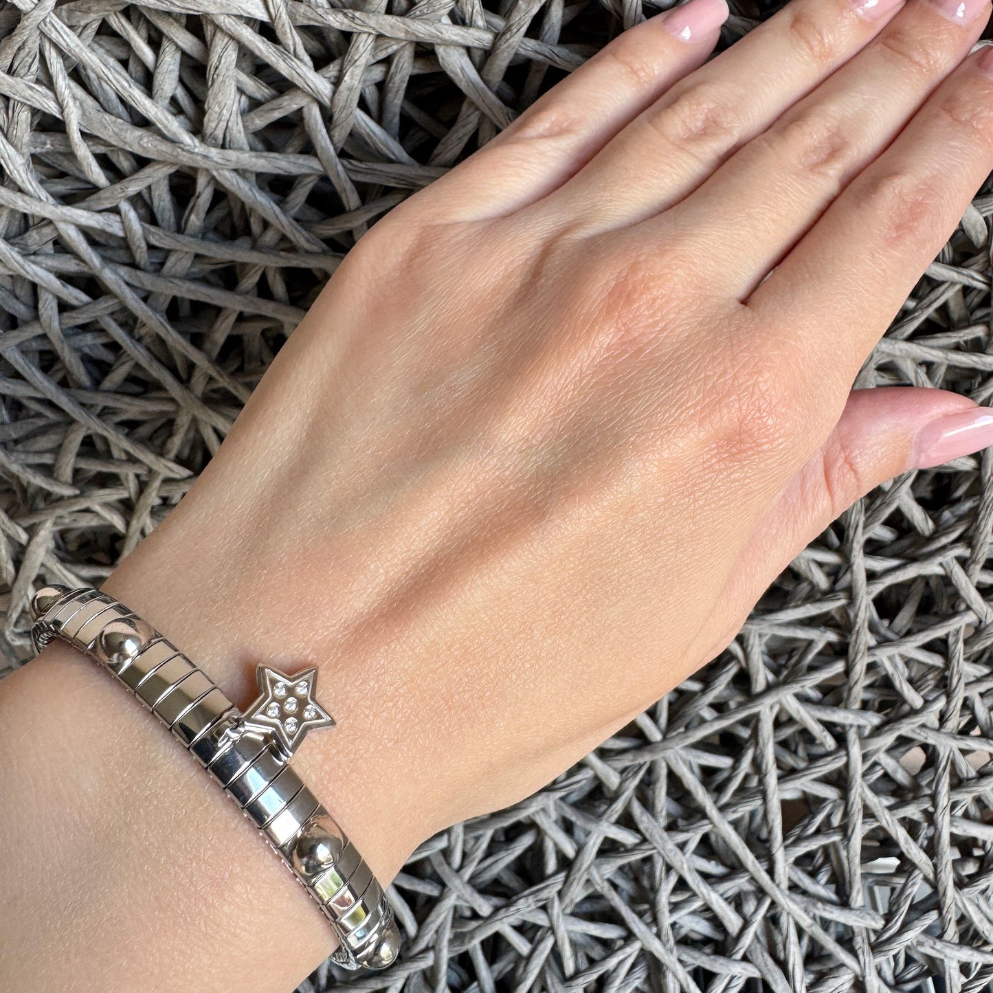 Nomination bracelet with star charm worn on a hand, showcasing elegant design