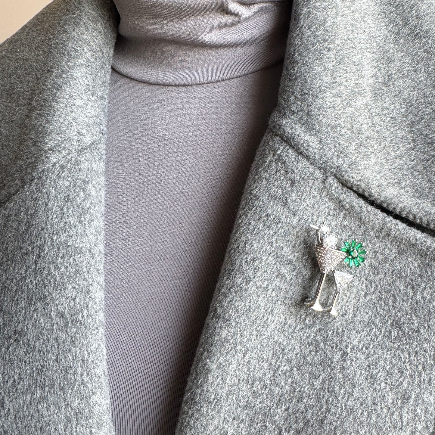 Cocktail-themed brooch with shiny zircon worn on coat as festive accent