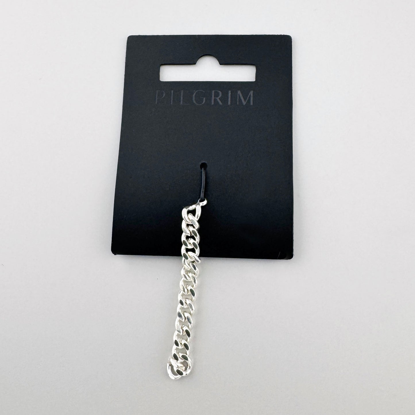 Pilgrim earring chain charm in a sleek link style on branded card