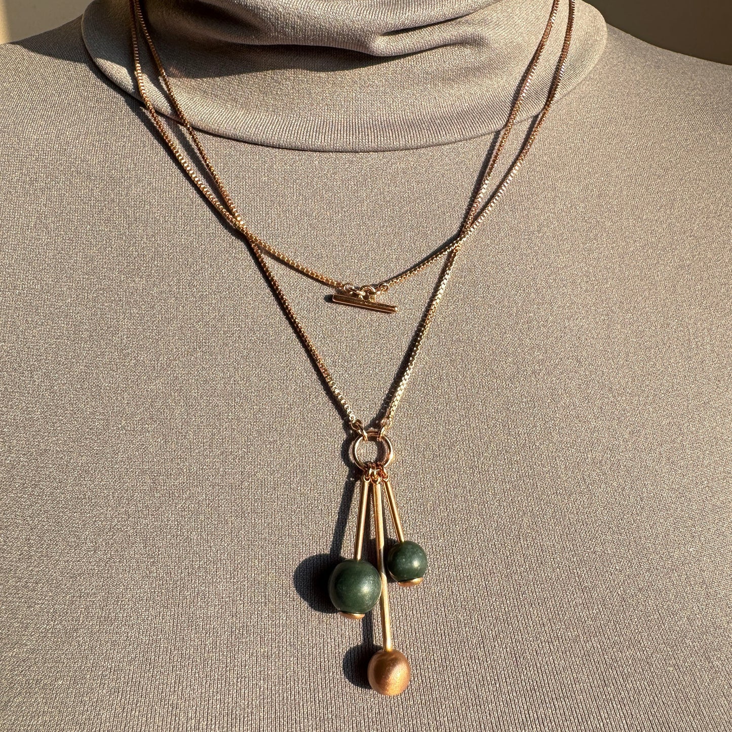 Rose gold necklace with green beads and elegant layered design