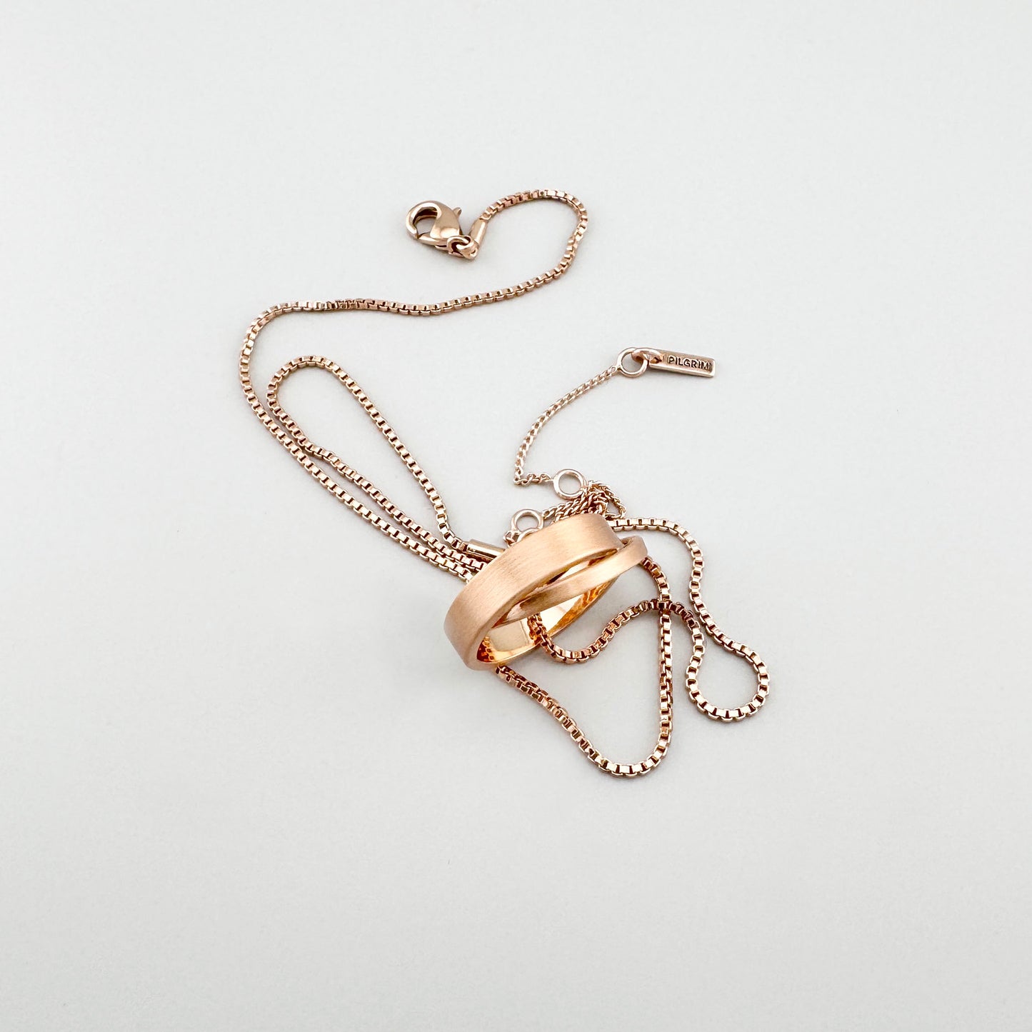 Halskette in Roségold mit verschlungenen Ringen und minimalistischem Design