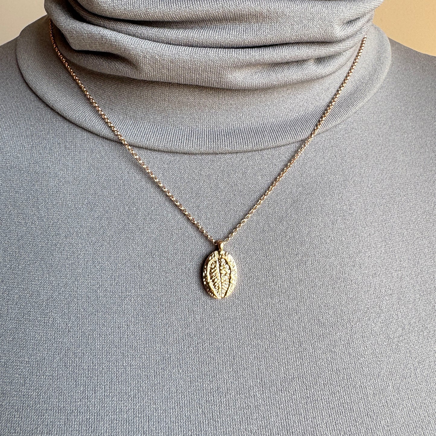 Rose gold Pilgrim necklace with oval leaf pendant worn layered on neck
