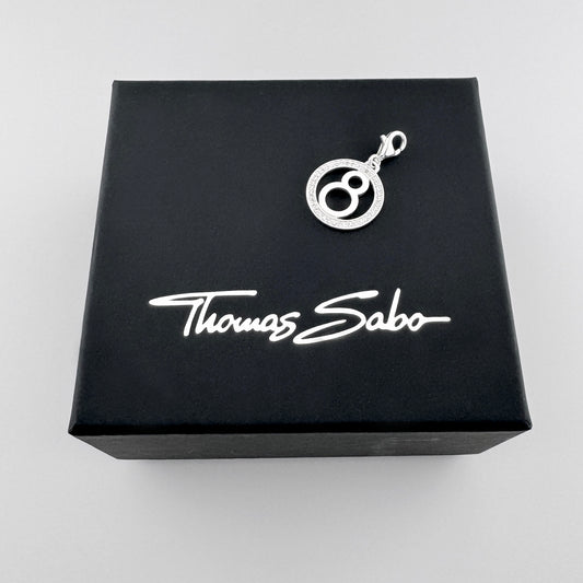 Silver number eight charm Thomas Sabo displayed on its branded black box