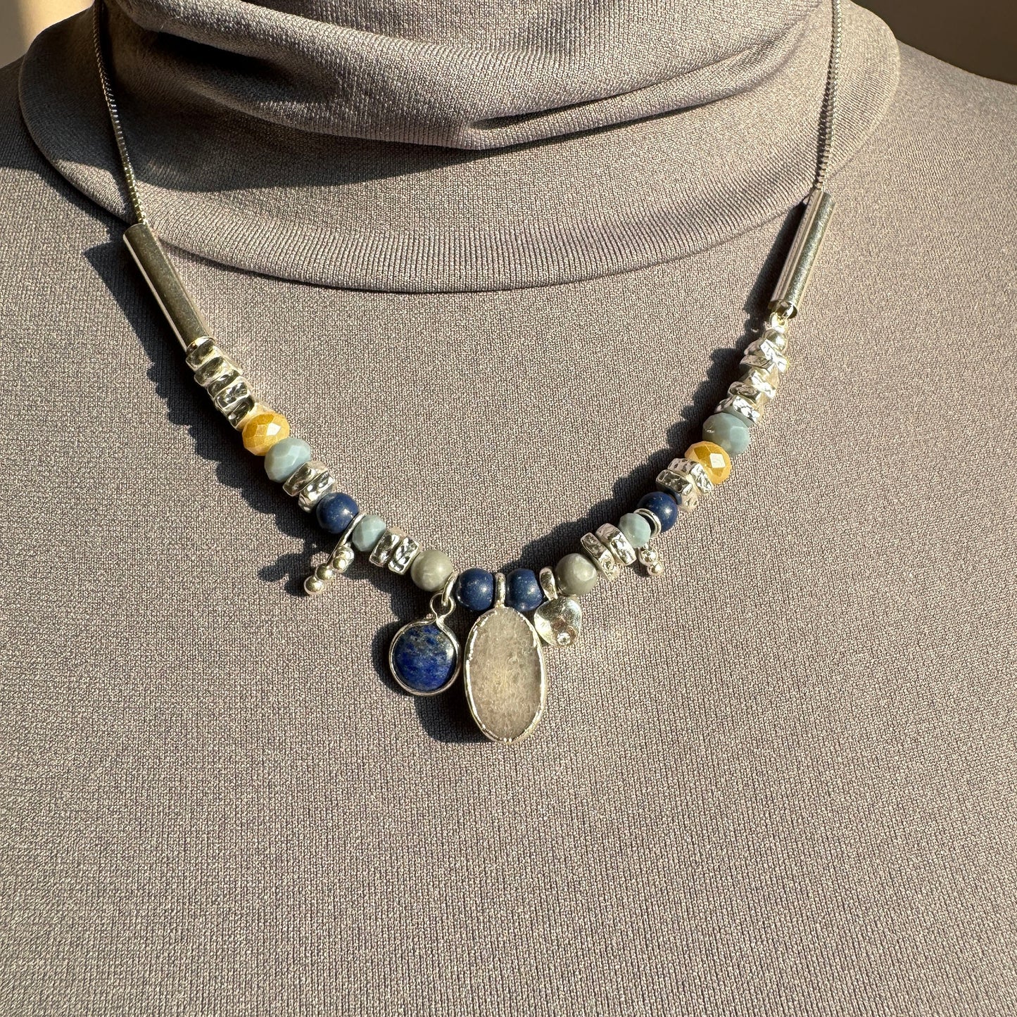 Stone necklace with lapis lazuli and quartz by Pilgrim displayed on a mannequin