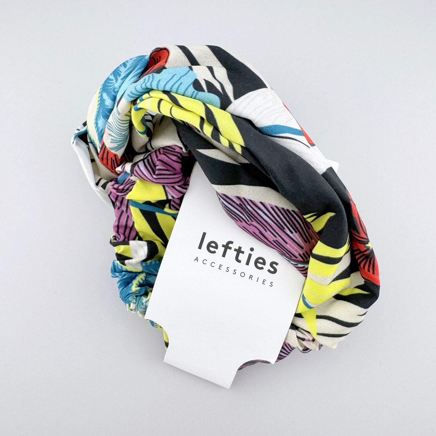Diadema Lefties con estampado tropical y tejido suave con etiqueta