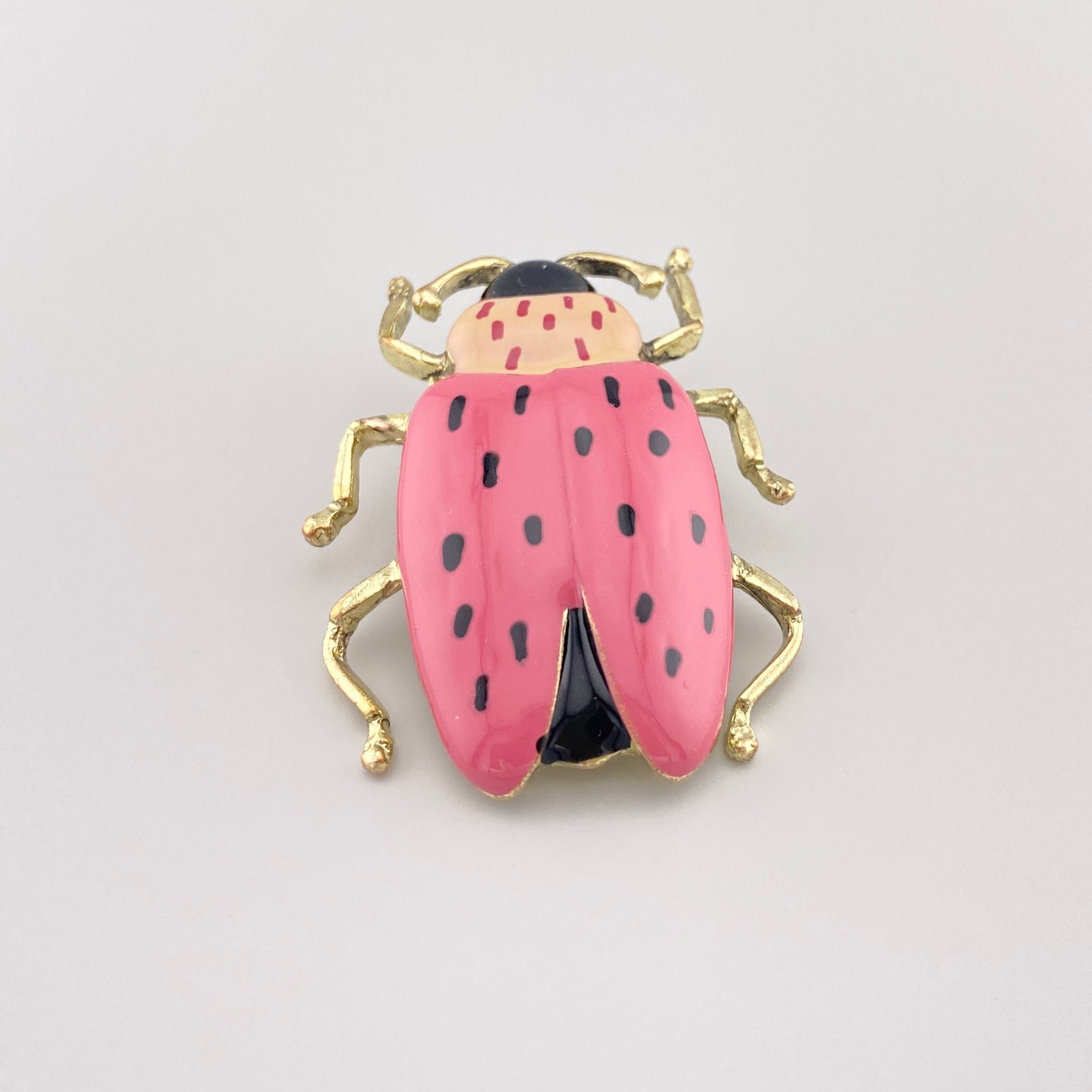 Käferbrosche in Rosa und Schwarz mit goldenen Beinen, Draufsicht