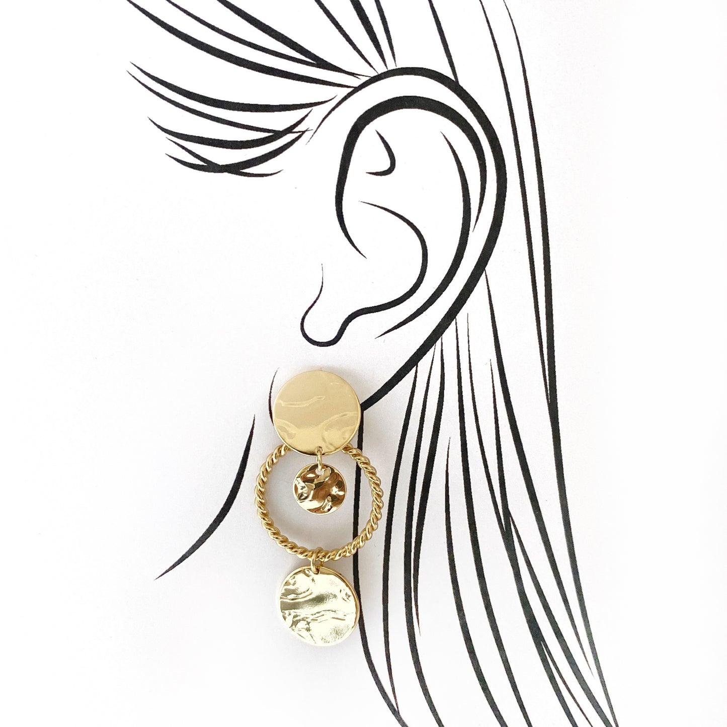 Gold geometric IRL earrings with hoops illustrated on ear