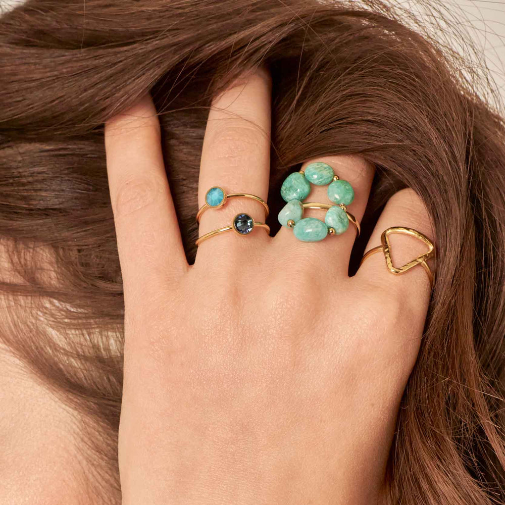 Gold-plated IRL ring with natural onyx cabochons worn on a woman's hand
