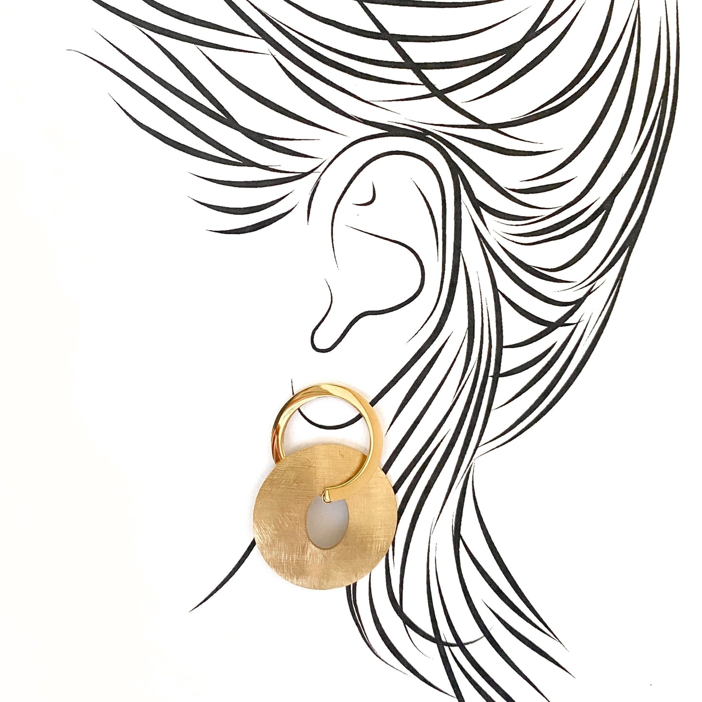 Sculptural oval earrings with brushed finish gently hugging the earlobe
