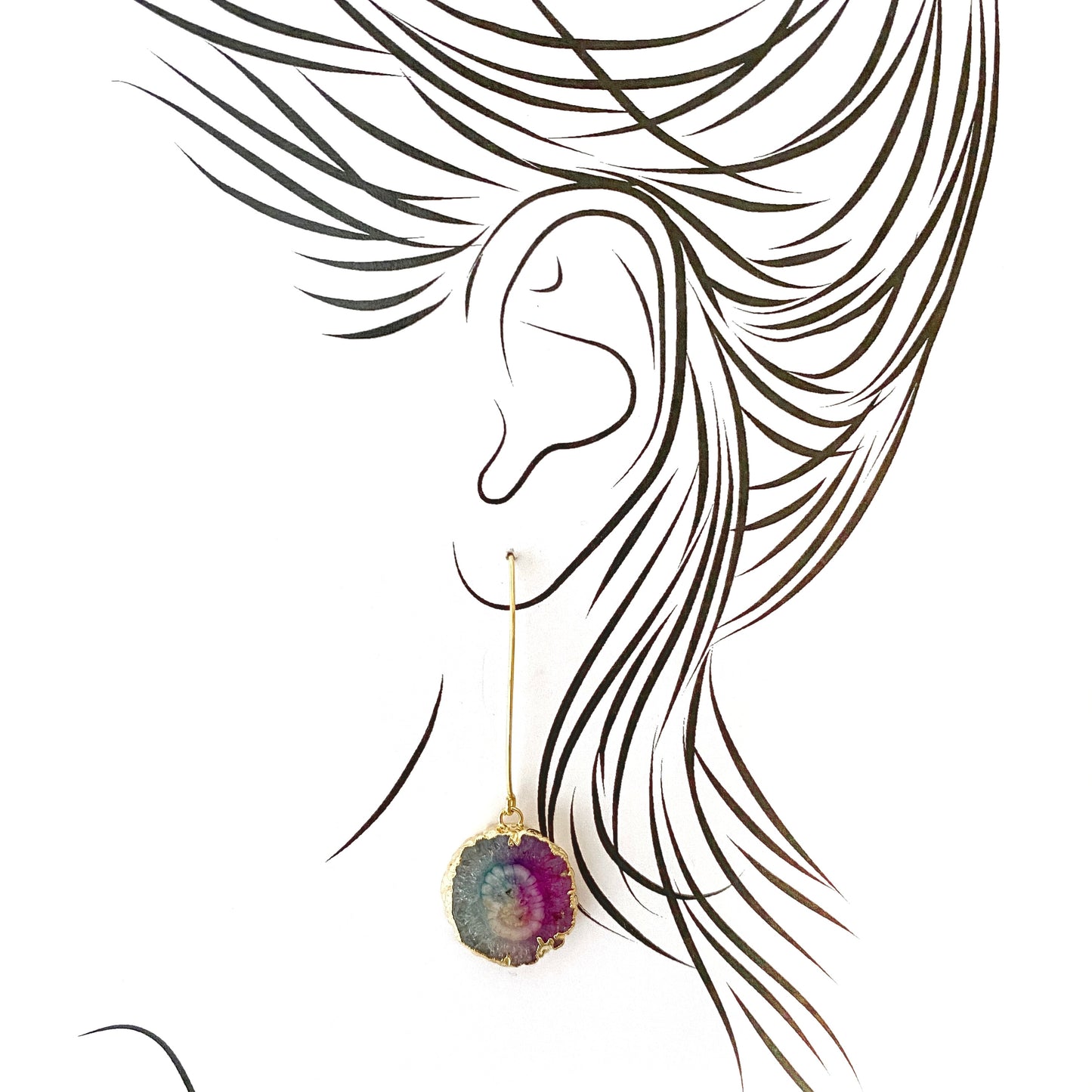 Artistic illustration of long gold-plated earrings with raw tourmaline stones
