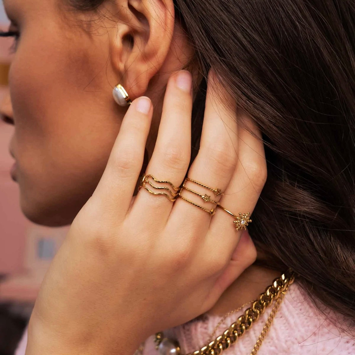 Triple band gold IRL ring with star detail worn elegantly on hand