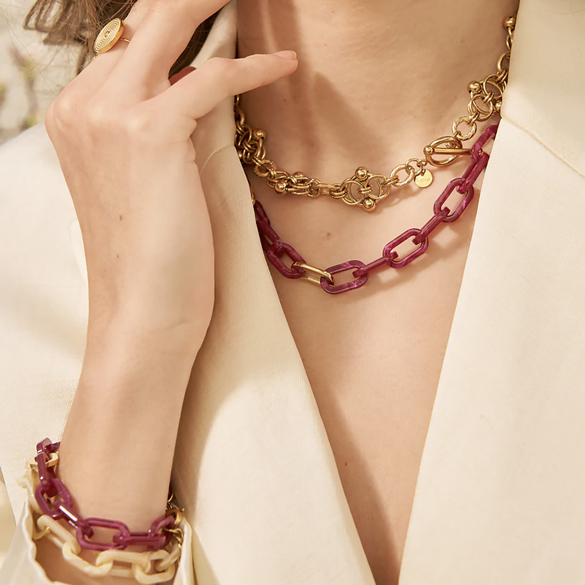 Necklace with deep pink acrylic links and gold-tone details, French brand Ikita.