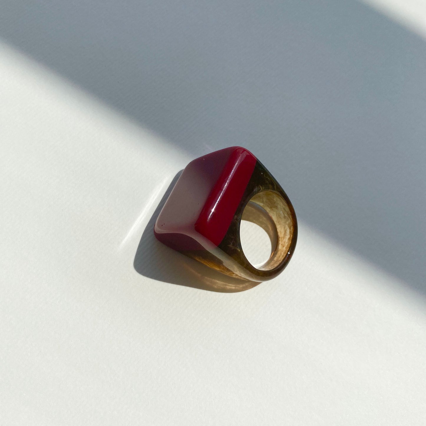 Stylish red ring with unique marble-effect accents.