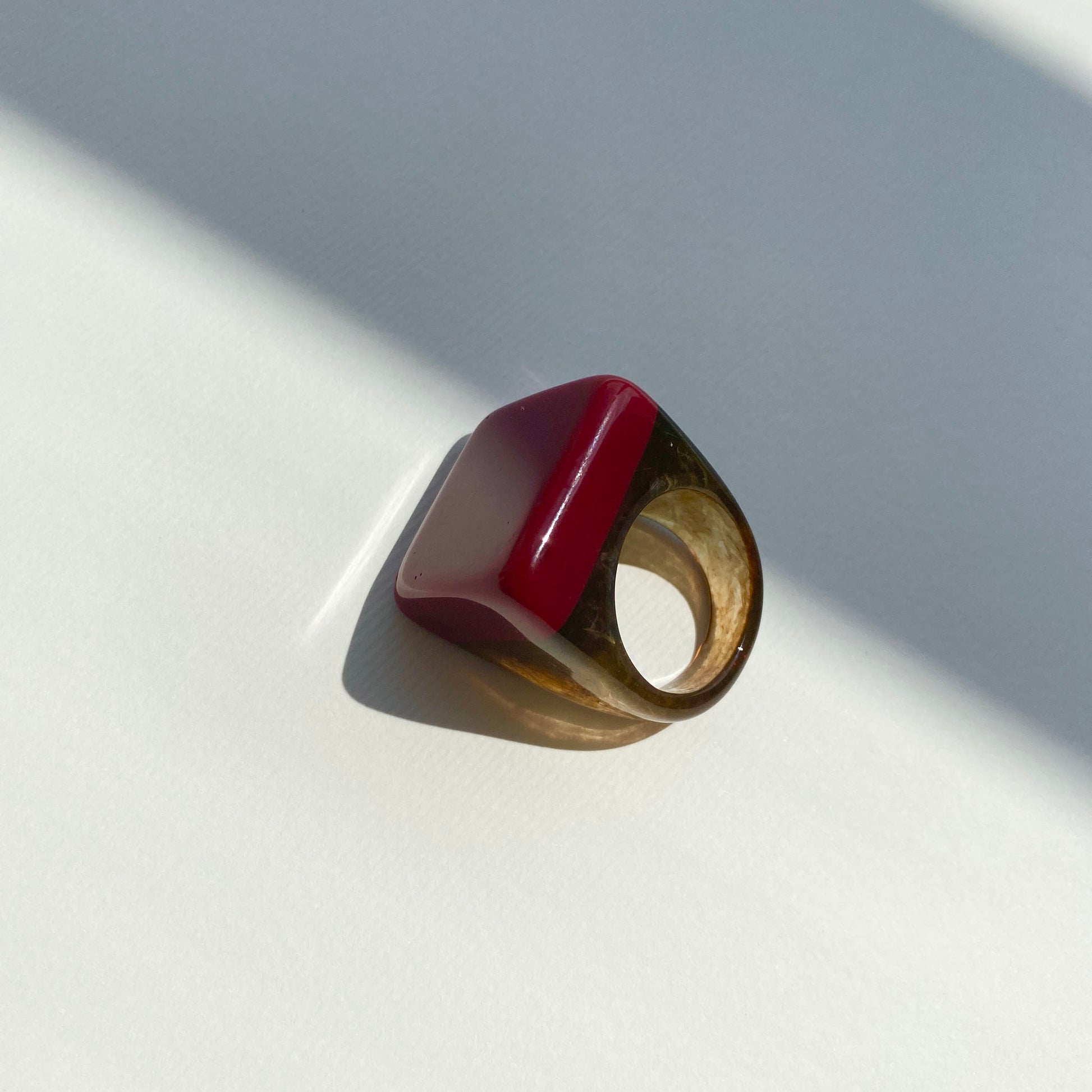 Stylish red ring with unique marble-effect accents.