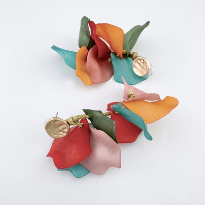 Colorful earrings with flower petals in shades of red, green, turquoise, orange, and pink, made of matte acrylic.