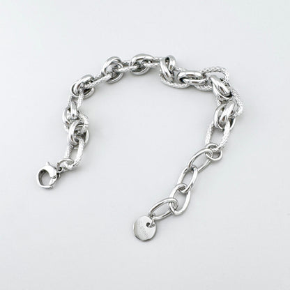Pulsera de acero inoxidable con eslabones lisos y trenzados en contraste, marca francesa Ikita.
