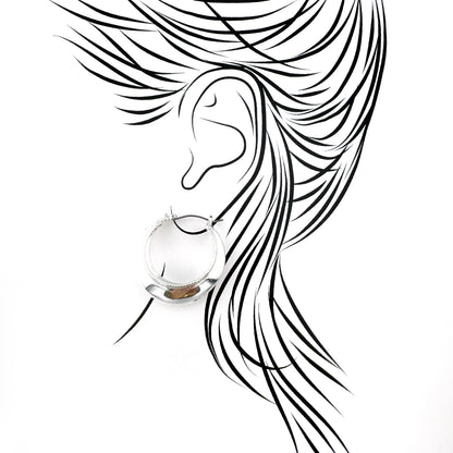 Mirror-finish hoop earrings with a wide design, Danish brand Pilgrim.
