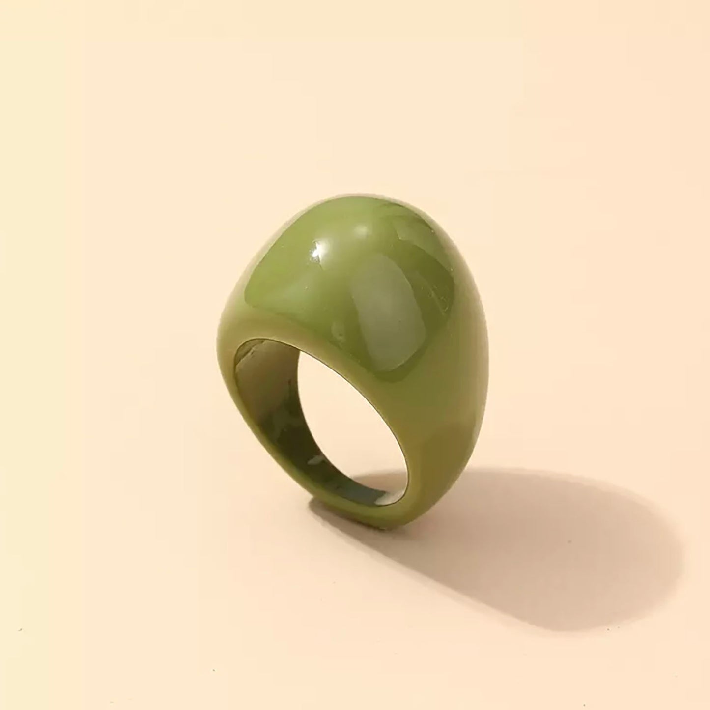 Olive-green ring with a glossy finish and rounded shape.