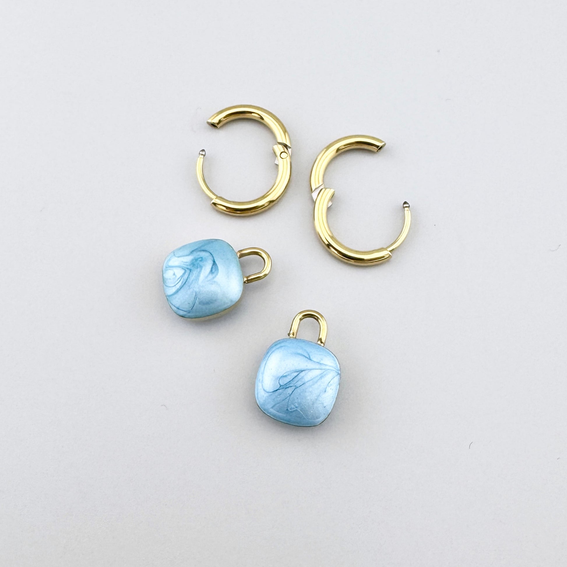 Créoles dorées avec pendentifs bleu clair effet marbré, marque française Cannelle.