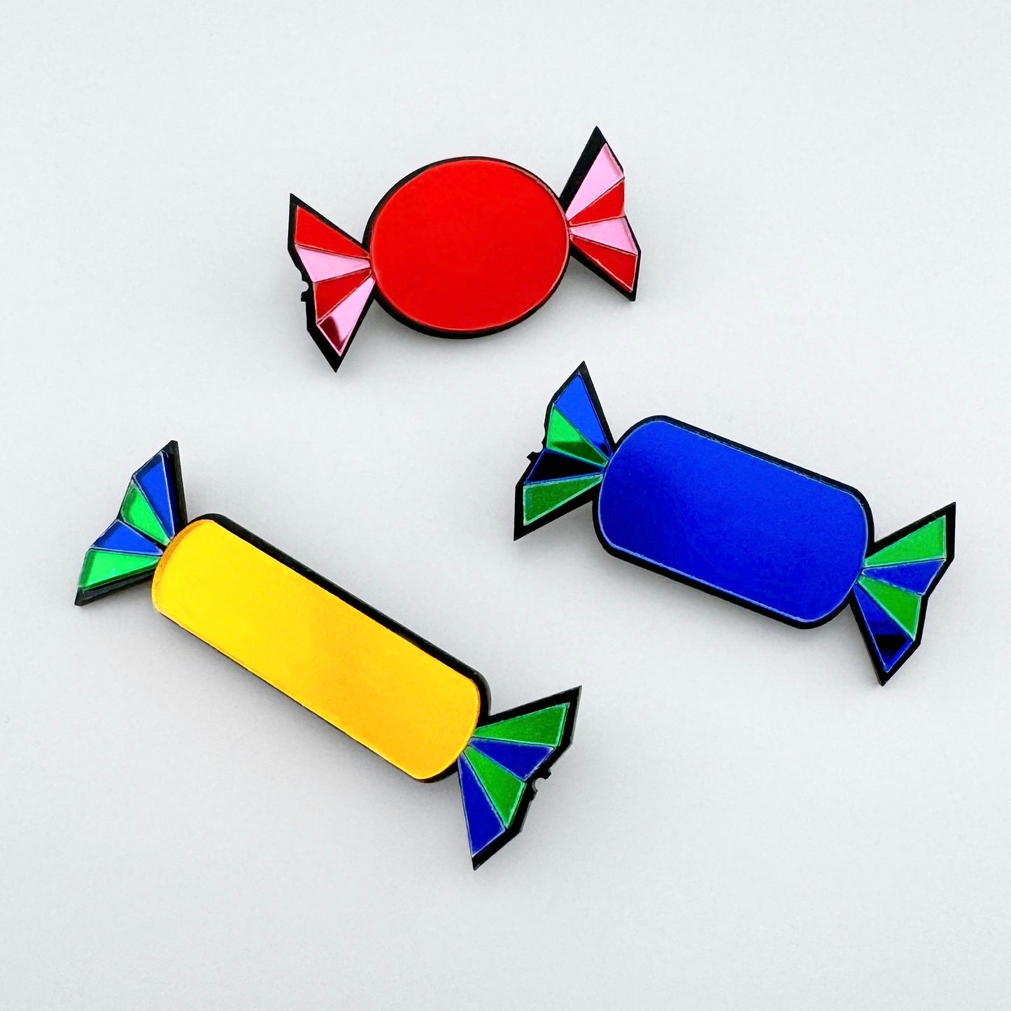 Set of three candy-shaped brooches in red, blue, and yellow colors, made of acrylic, Spanish brand Sonata.