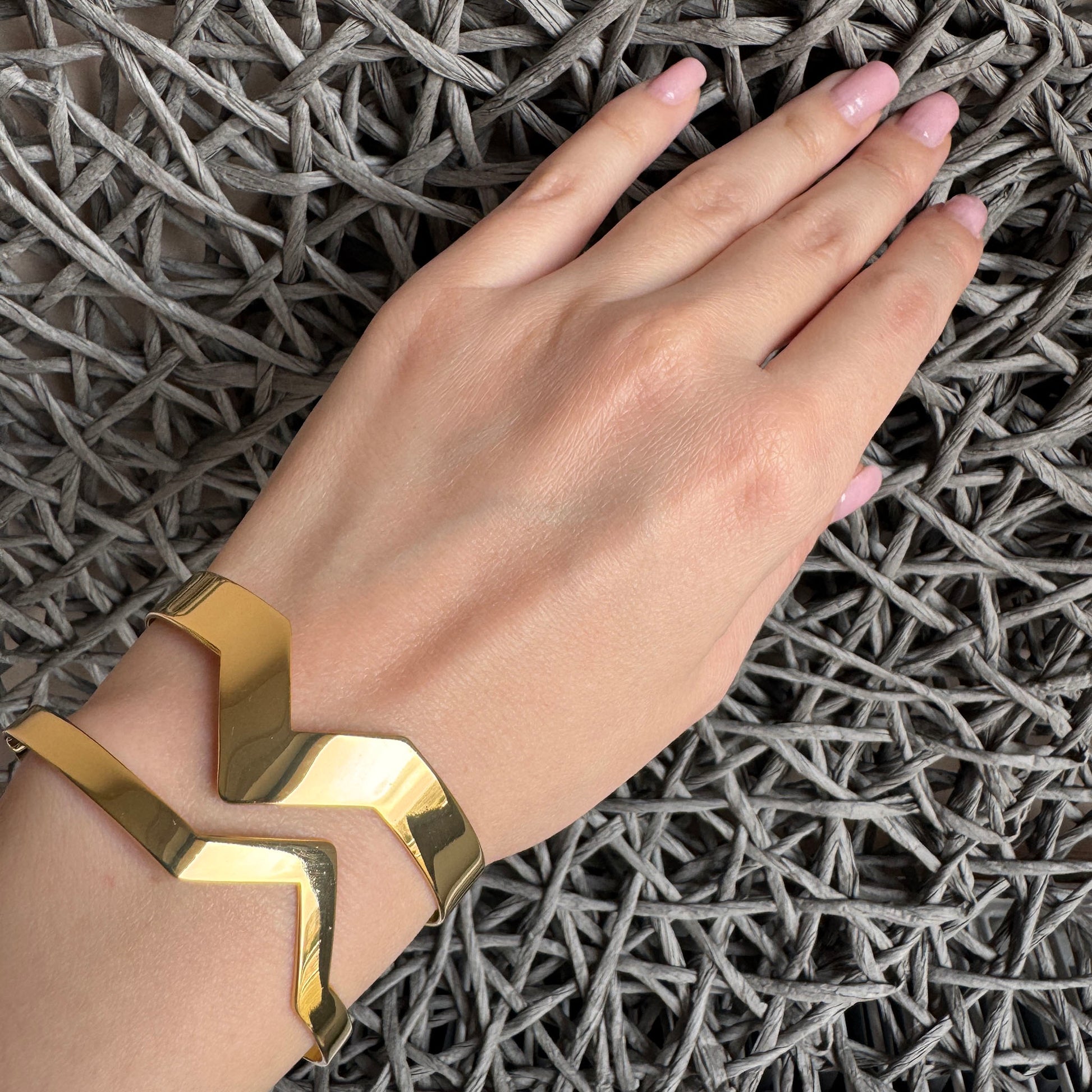 Open cuff bracelet with a geometric gold-tone design, French brand IRL.