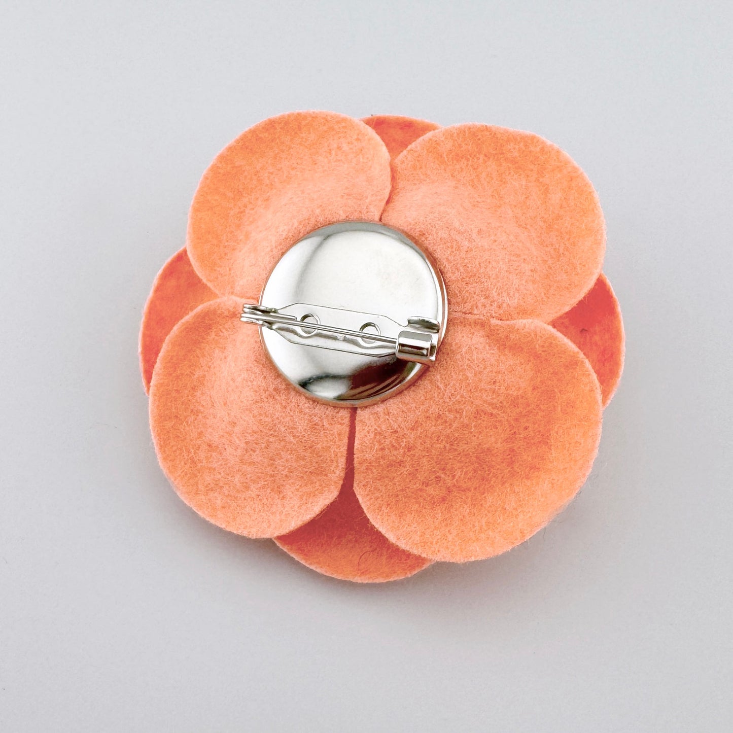 Filzbroche in warmem Orange, in Form einer dreidimensionalen Blume, spanische Marke Sonata.