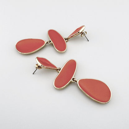 Dangling gold-colored earrings with coral enamel elements in various shapes, Spanish brand Sonata.