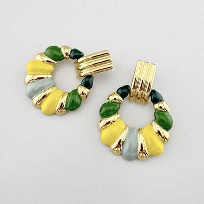 Gold earrings with multicolored enamel in shades of green, yellow, and gray, French brand Ikita.