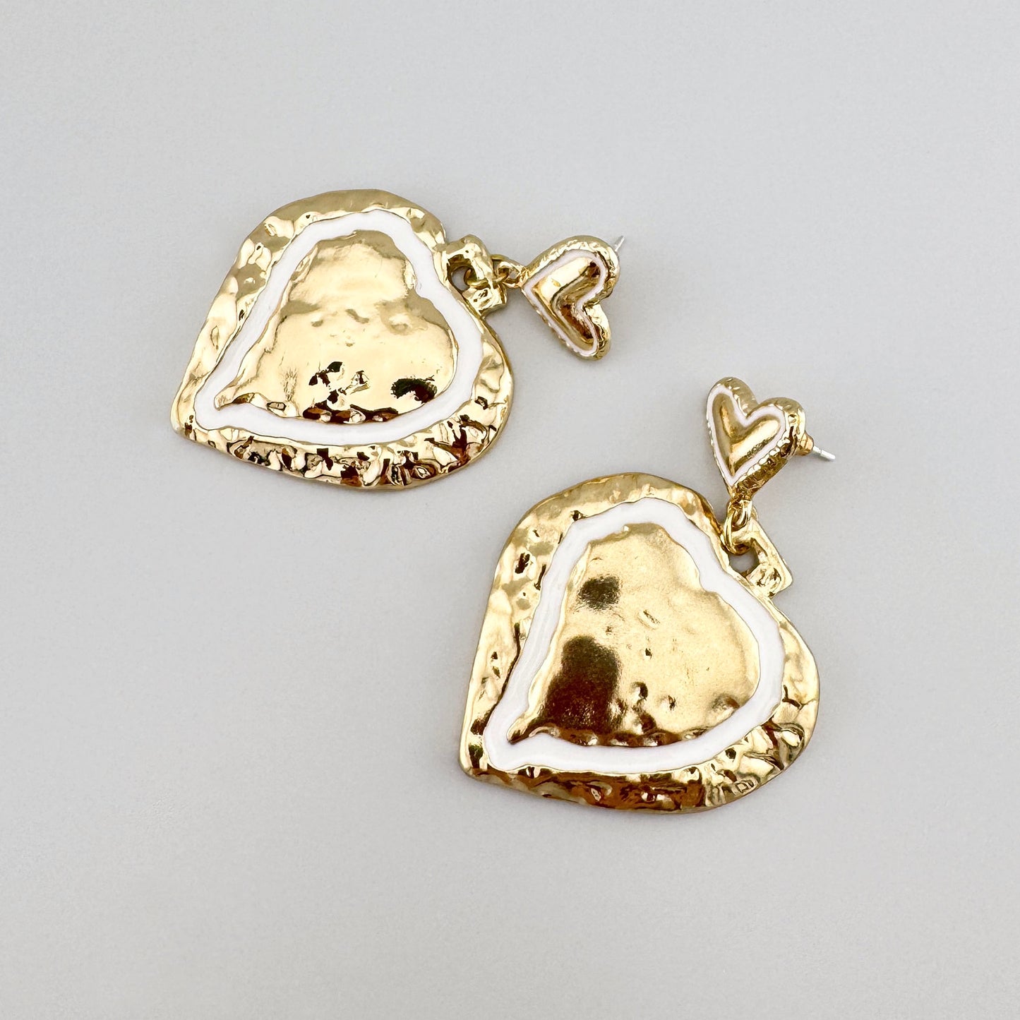 Heart-shaped earrings in gold color, by Spanish brand Sonata.