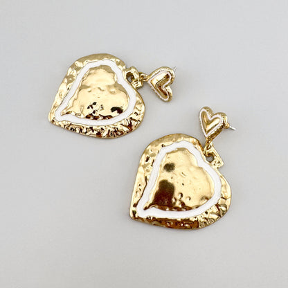 Heart-shaped earrings in gold color, by Spanish brand Sonata.