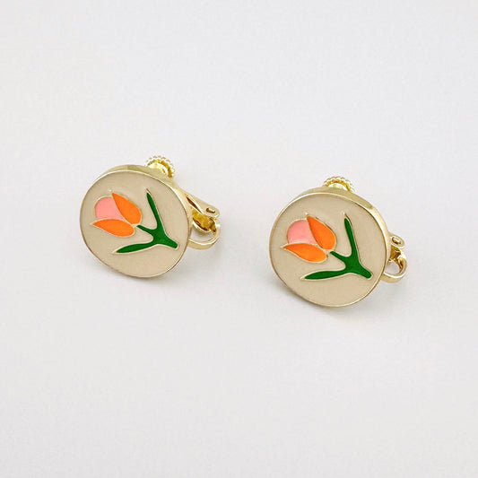 Floral clip-on earrings with pink, orange, and green details on a gold-tone base.