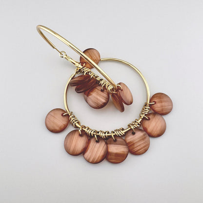 Golden hoop earrings with shell pendants, Spanish brand Sonata.