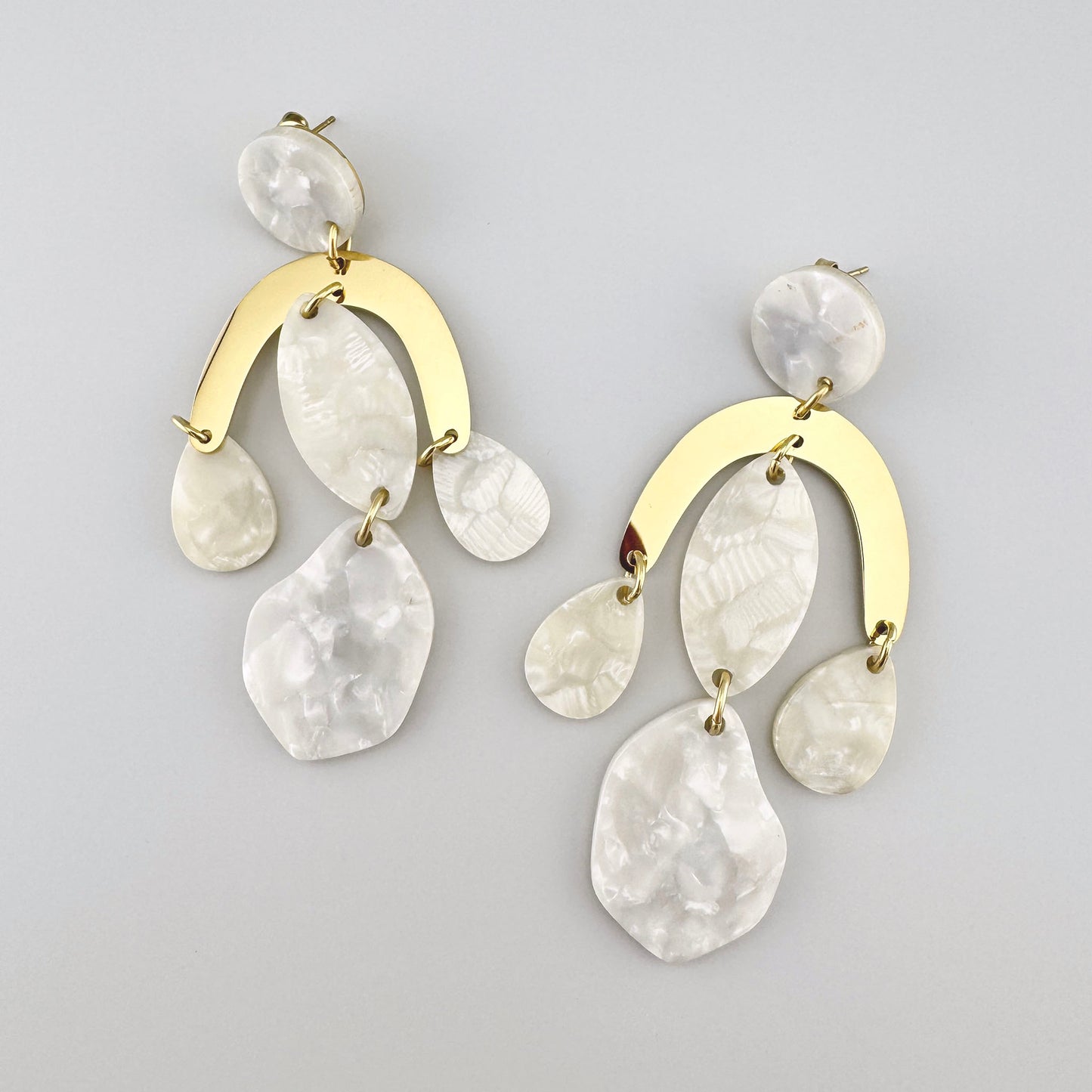 Dangling earrings with gold elements and mother-of-pearl pendants, French brand Ikita.