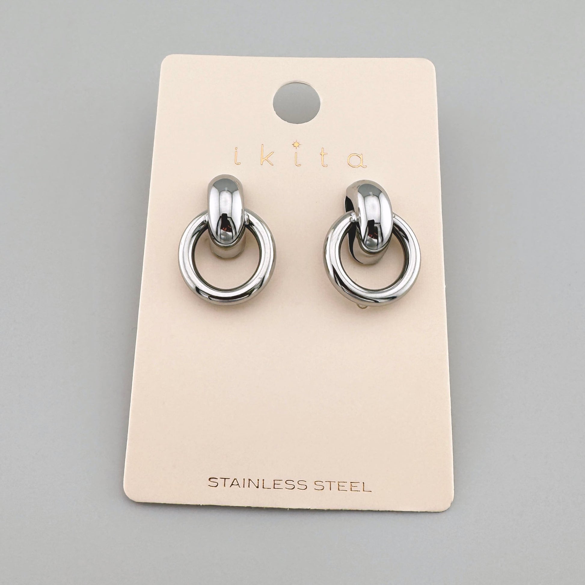 Silver-colored earrings with double rings, by French brand Ikita.