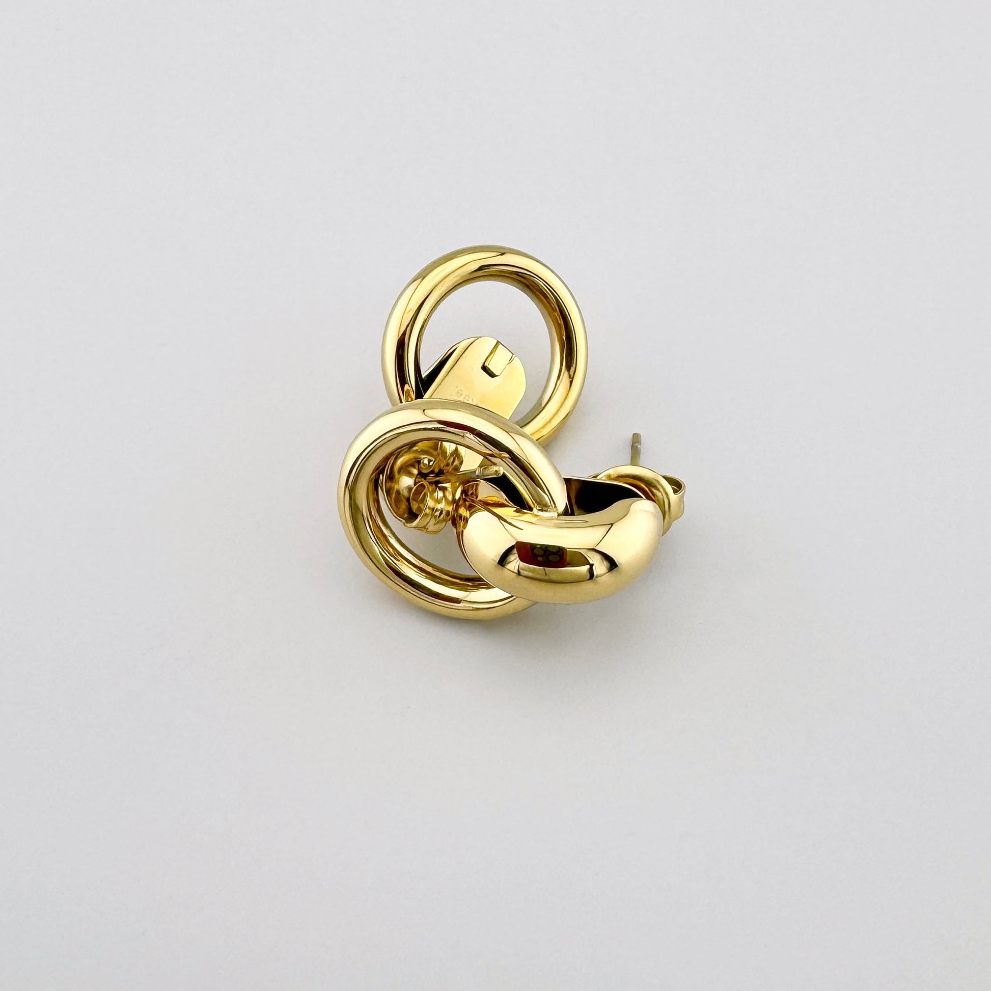 Gold-colored earrings with double rings, by French brand Ikita.