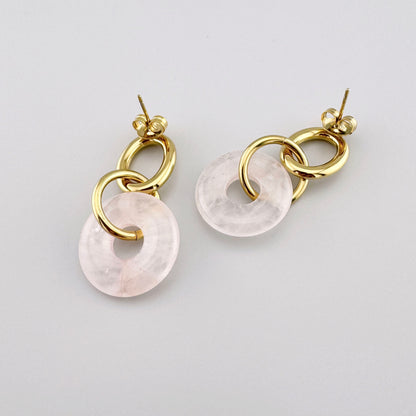 Dangling earrings with gold-plated chain links and a pink element, French brand Ikita.