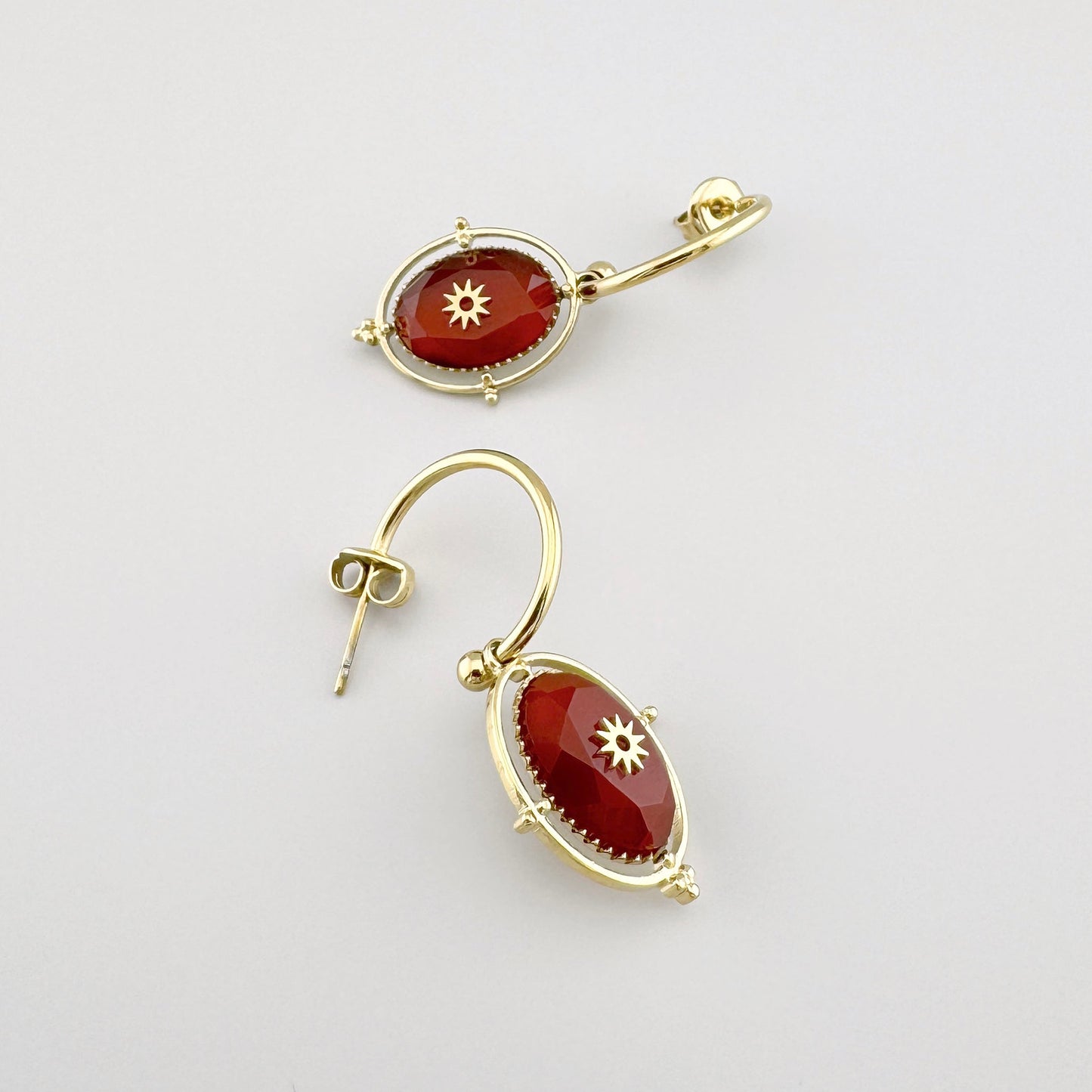 Earrings with red carnelian and gold star motif, French brand Ikita.