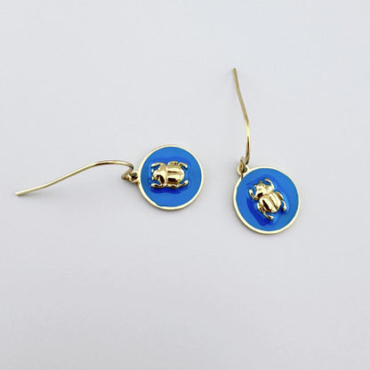 Earrings with blue enamel and a gold scarab motif, French brand Ikita.