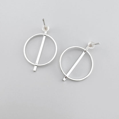 Circle earrings with silver finish and a straight line, minimalist design.