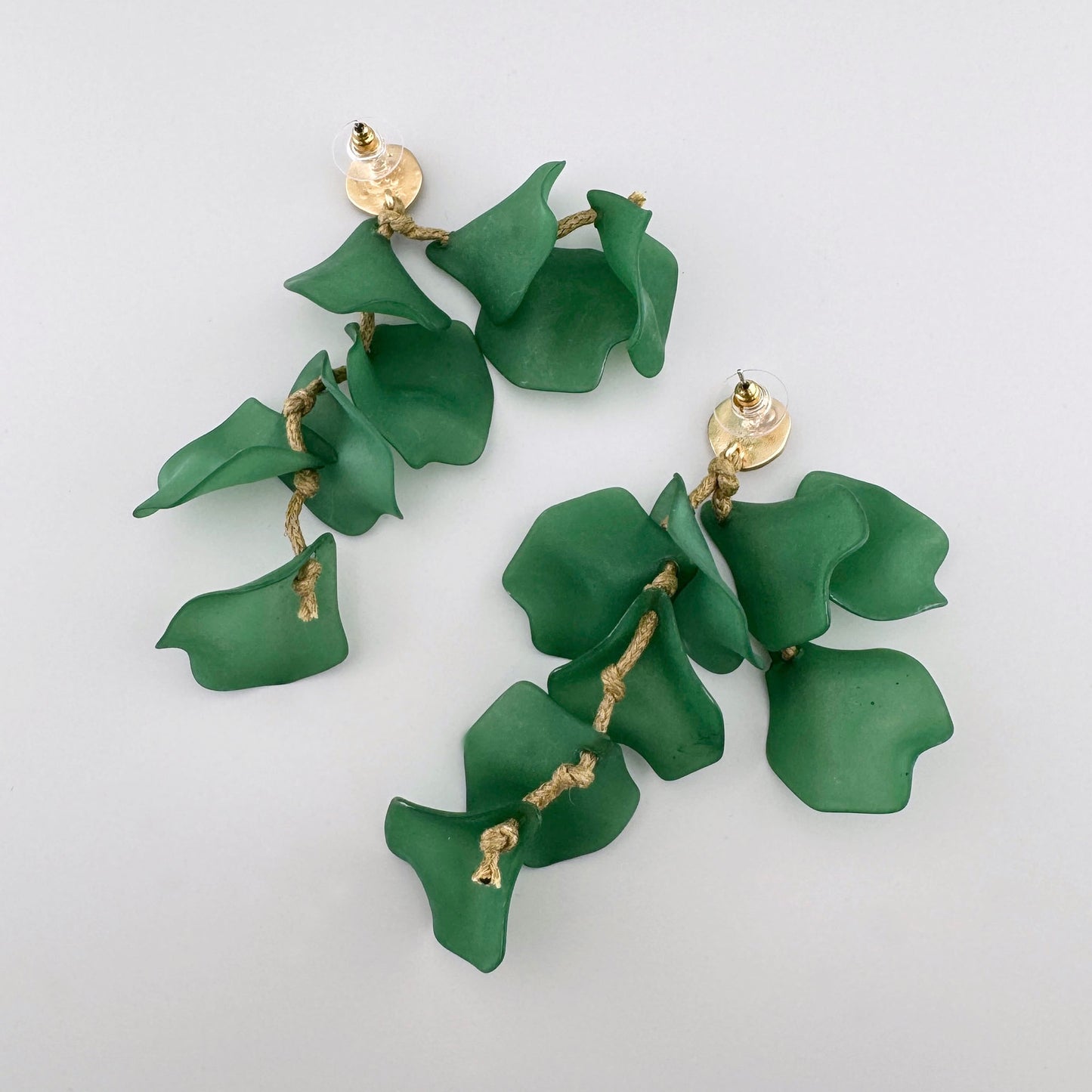 Earrings with matte leaf-shaped elements in deep green, decorated with cords and gold-toned clasp, Spanish brand Sonata.