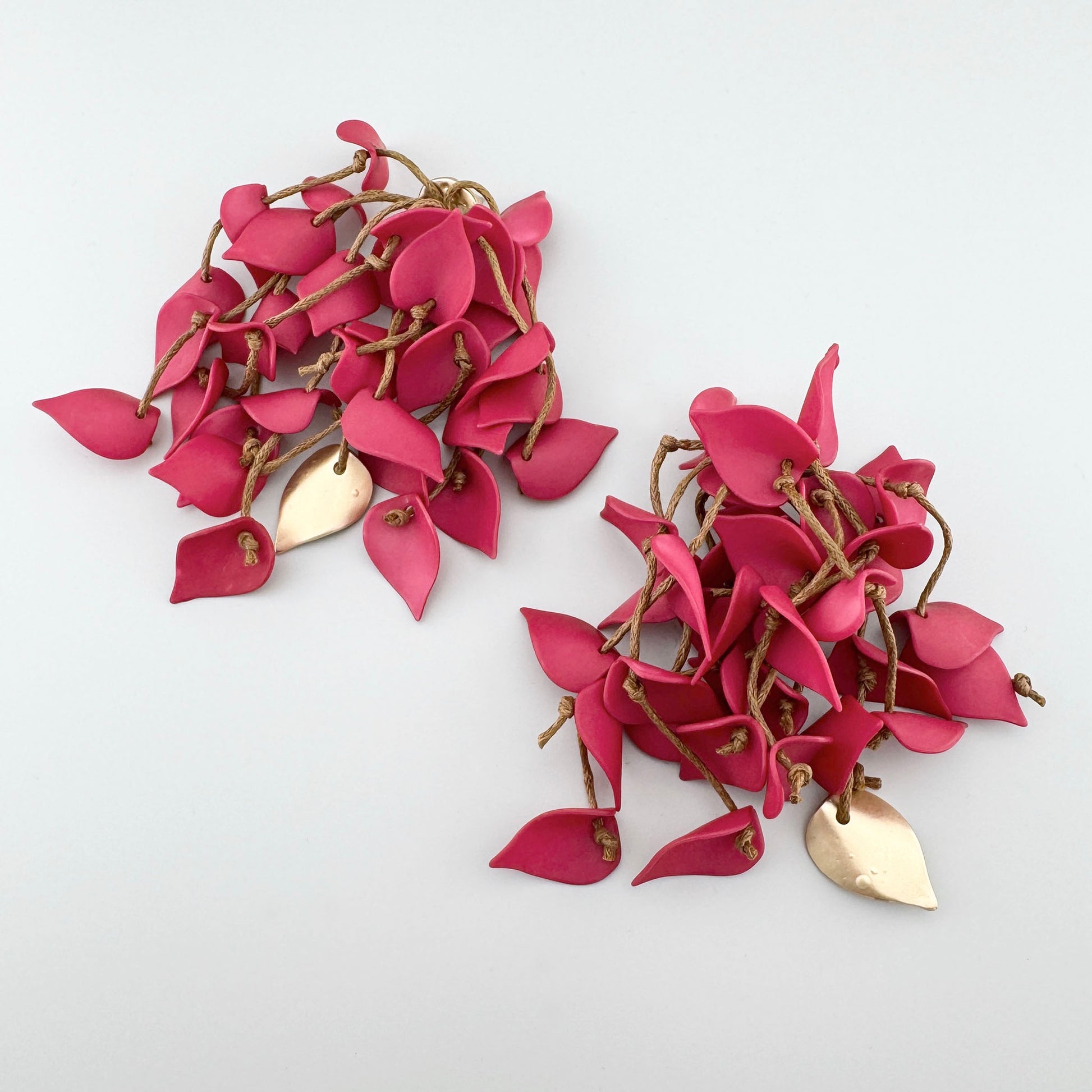 Pink leaf-shaped earrings on a natural cord with a matte finish. Brand Sonata.