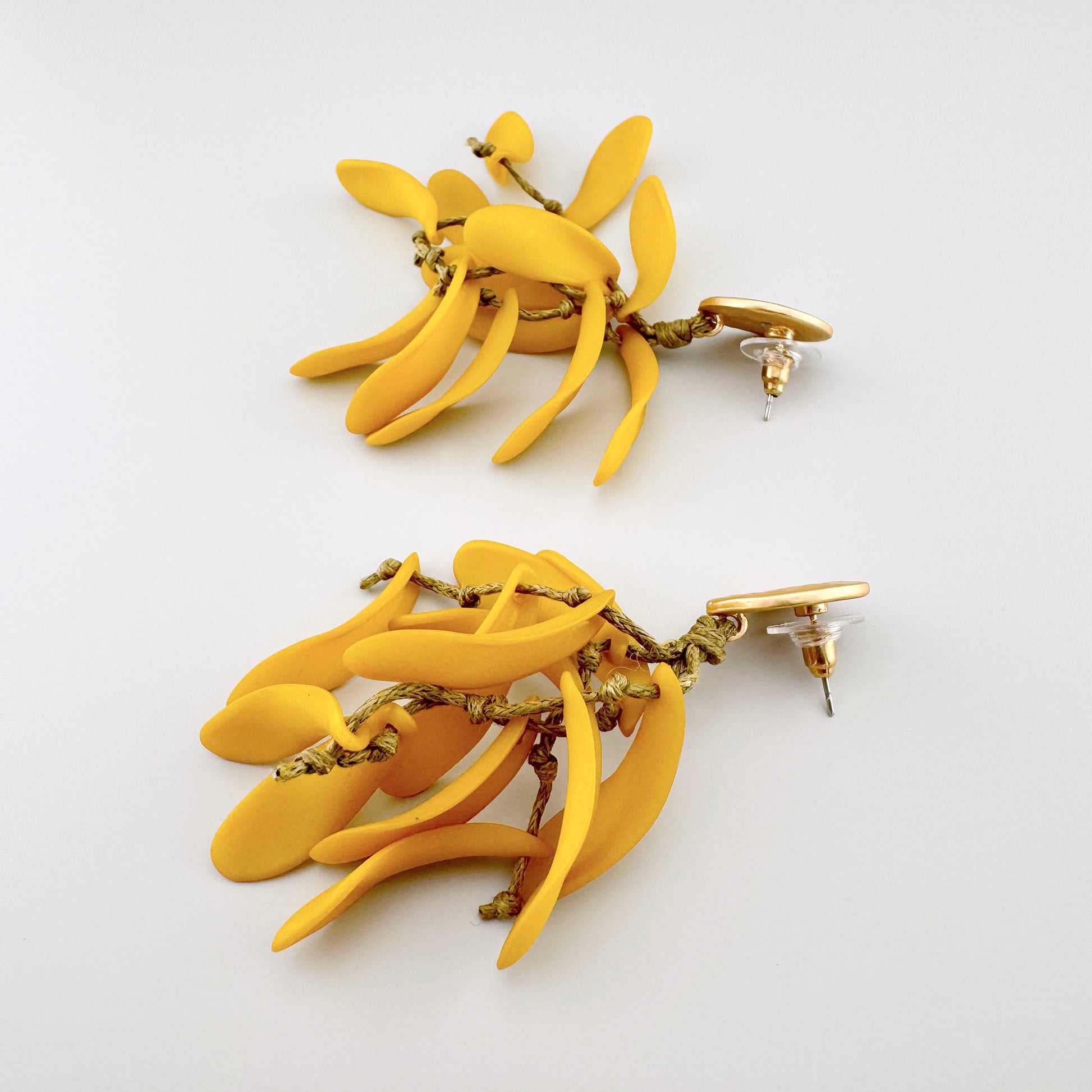 Yellow earrings with a cascading form resembling delicate branches, made from lightweight material. Brand Sonata.