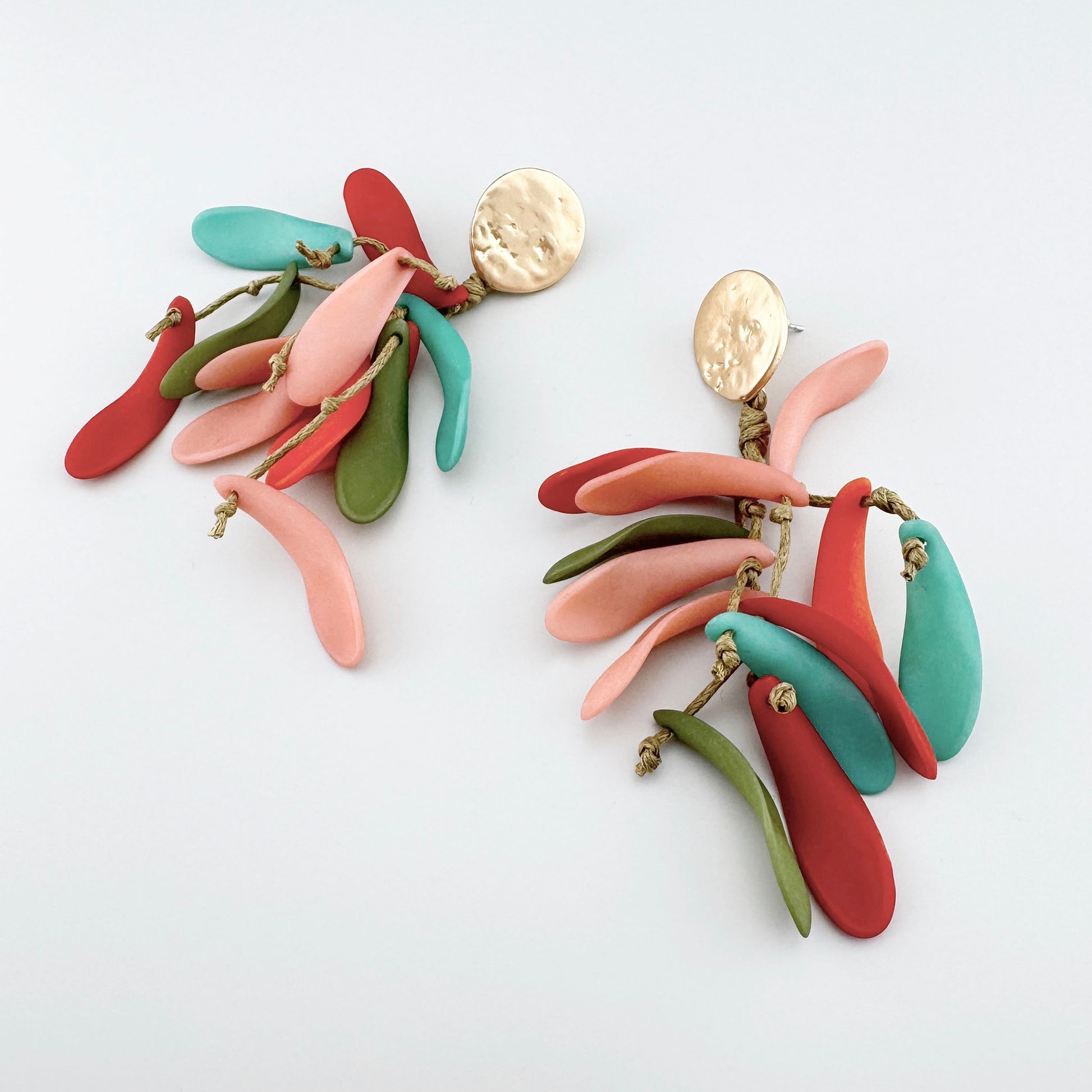 Earrings with multicolored, dangling elements in shades of red, green, turquoise, and pink. Brand Sonata.