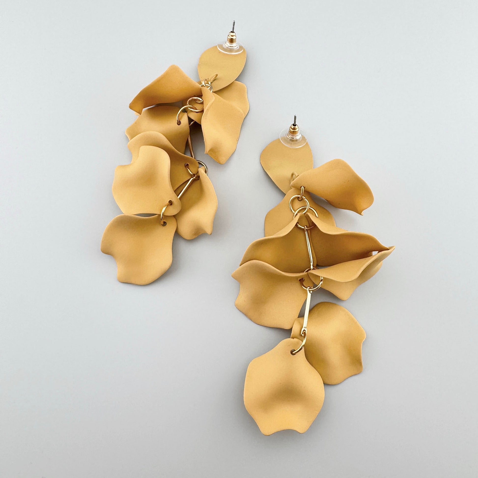 Yellow petal-shaped earrings with gold connectors.