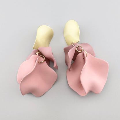 Earrings with pink petals and gold accents.