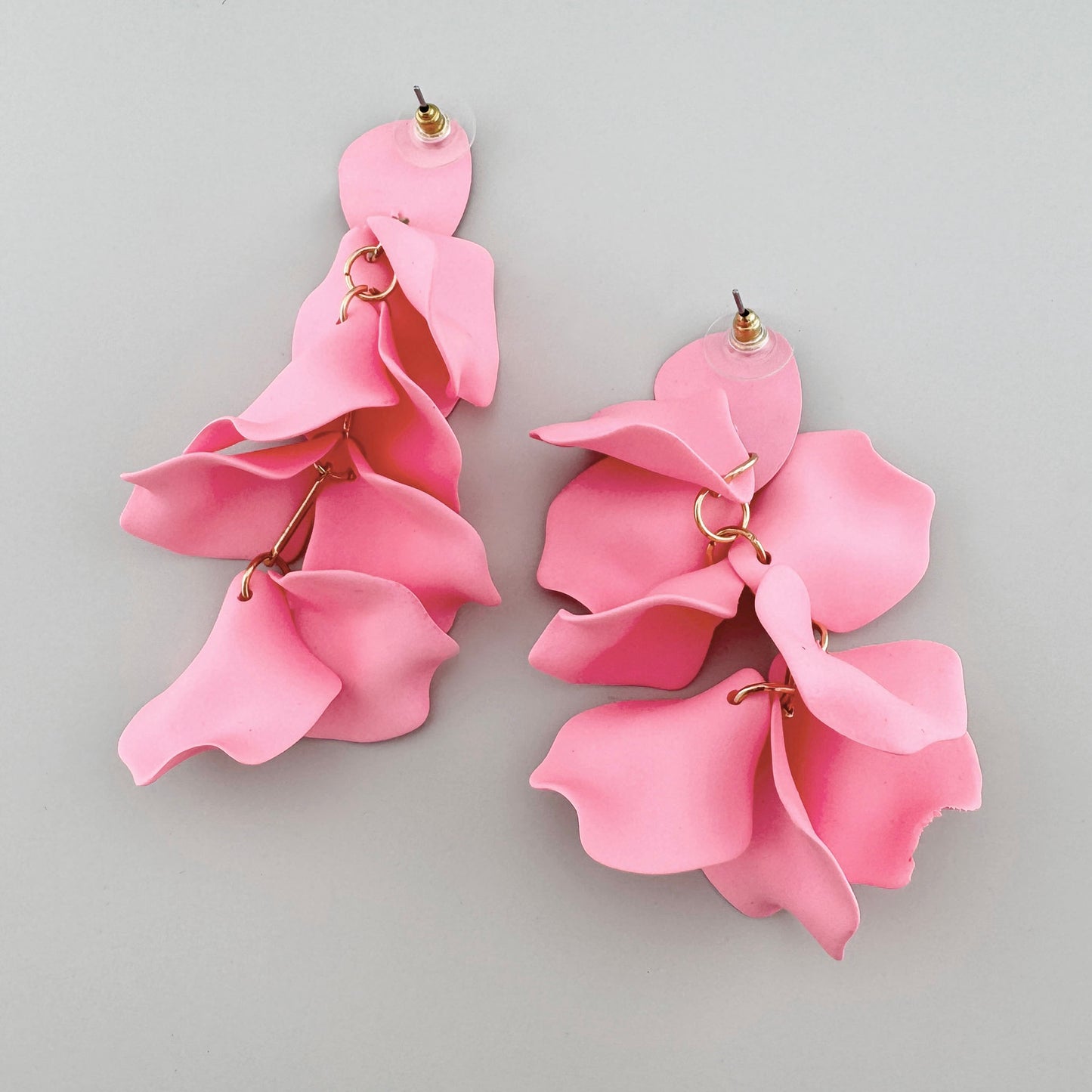 Bold pink petal-shaped earrings with gold connectors.