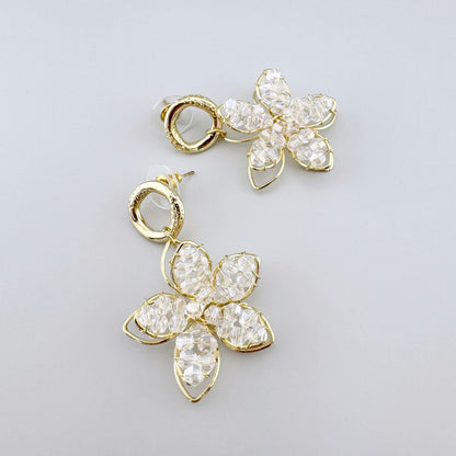 Flower-shaped earrings with gold frames and clear crystals.